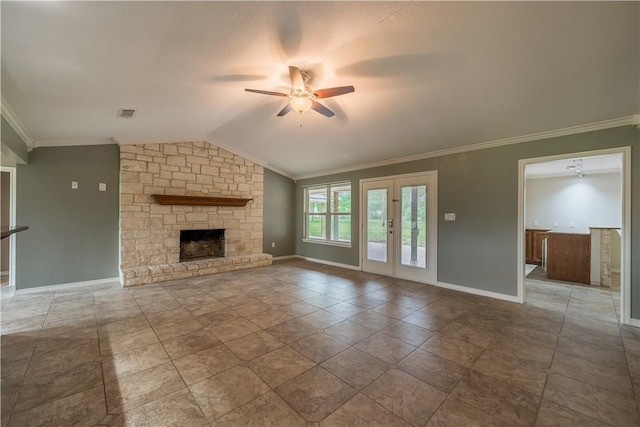 unfurnished living room with ceiling fan, french doors, vaulted ceiling, a fireplace, and ornamental molding