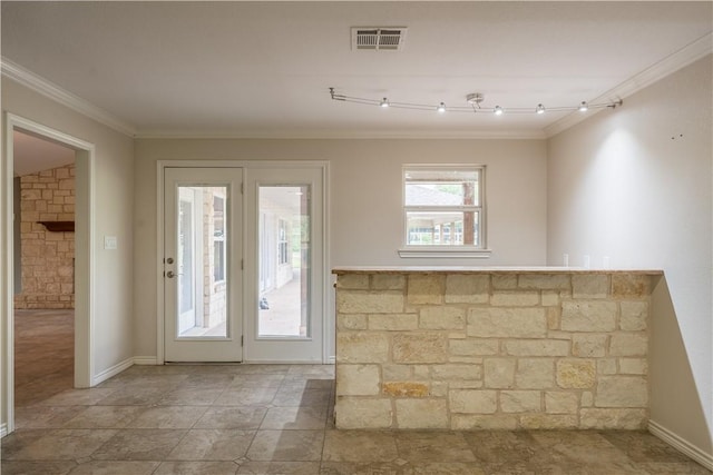 doorway featuring track lighting and ornamental molding