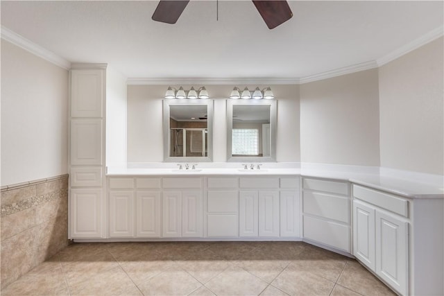 bathroom with vanity, tile patterned floors, tile walls, and crown molding