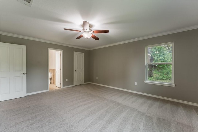 unfurnished bedroom featuring light carpet, ensuite bath, ceiling fan, and ornamental molding