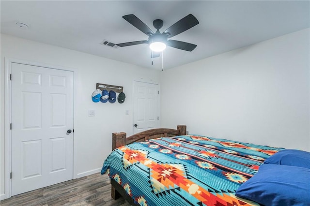 bedroom featuring ceiling fan and dark hardwood / wood-style flooring