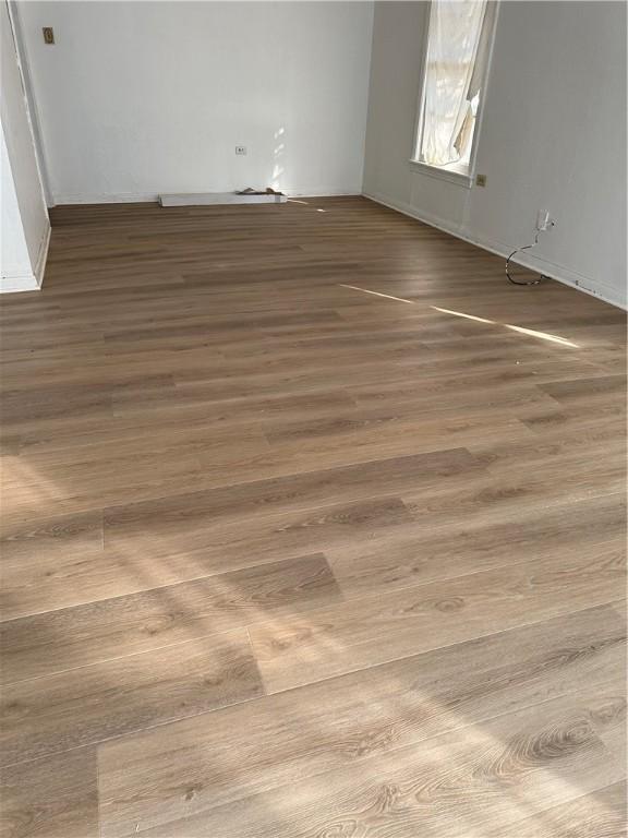 spare room with wood-type flooring