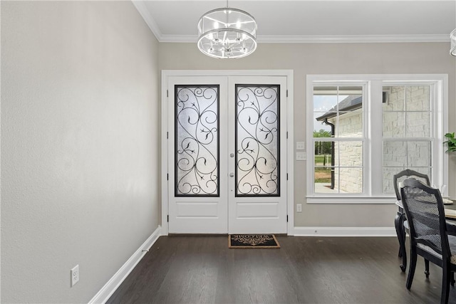 entryway featuring a chandelier, dark hardwood / wood-style flooring, crown molding, and french doors