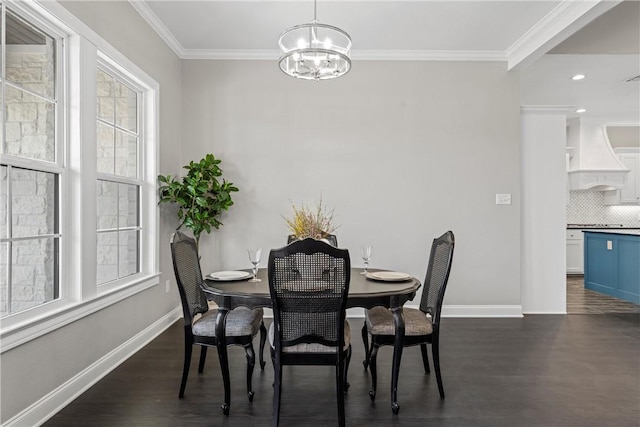 dining space with crown molding, dark hardwood / wood-style flooring, and a chandelier