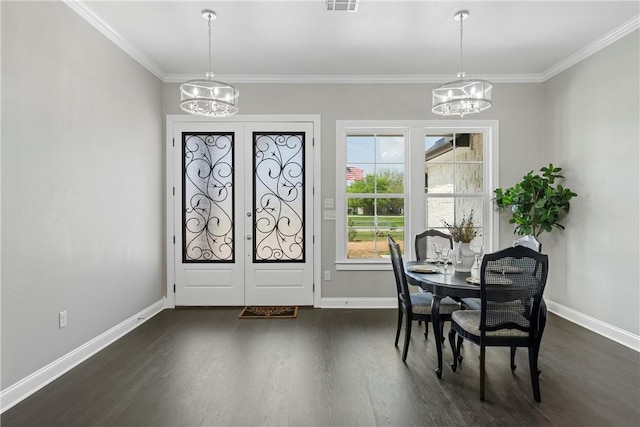 dining area with a notable chandelier, dark hardwood / wood-style flooring, ornamental molding, and french doors