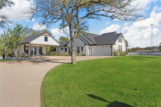 modern farmhouse style home with a front lawn, covered porch, and a garage