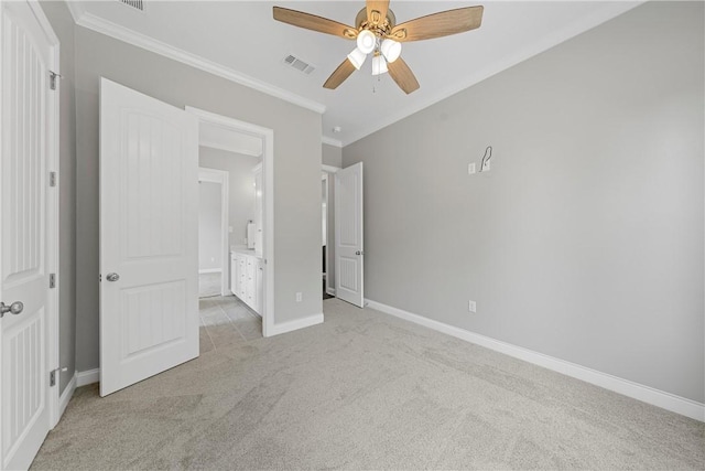 unfurnished bedroom with ceiling fan, ensuite bathroom, ornamental molding, and light carpet