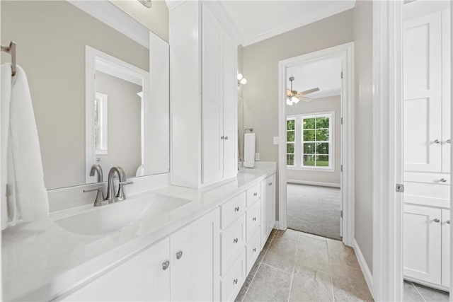 bathroom with tile patterned floors, ceiling fan, ornamental molding, and vanity