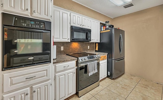 kitchen featuring backsplash, a textured ceiling, black appliances, white cabinets, and light tile patterned flooring