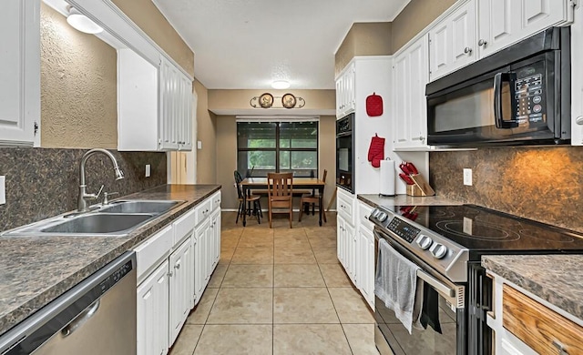 kitchen featuring backsplash, sink, black appliances, white cabinets, and light tile patterned flooring