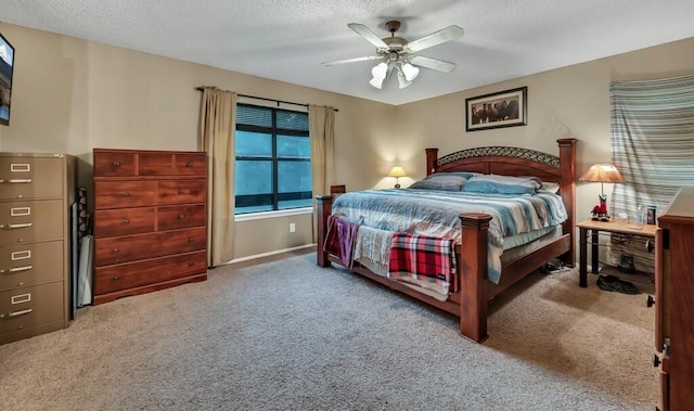 bedroom with ceiling fan, carpet floors, and a textured ceiling