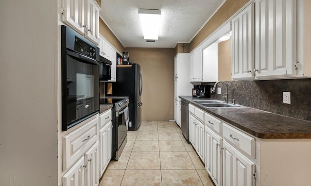 kitchen with tasteful backsplash, sink, black appliances, white cabinetry, and light tile patterned flooring