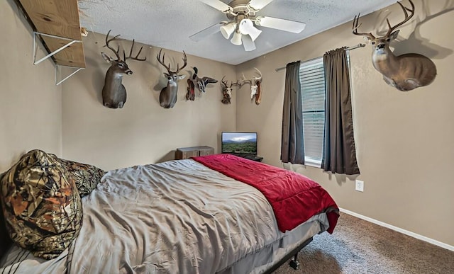 bedroom featuring ceiling fan, carpet floors, and a textured ceiling