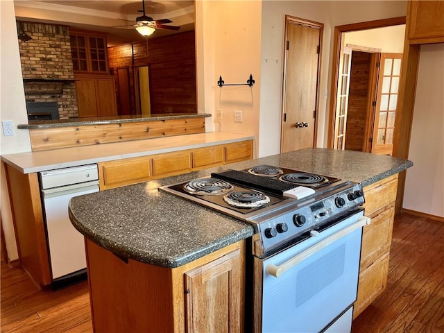 kitchen featuring white range oven, crown molding, ceiling fan, and wood-type flooring