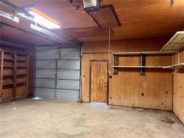 garage with wood walls, wooden ceiling, and a garage door opener