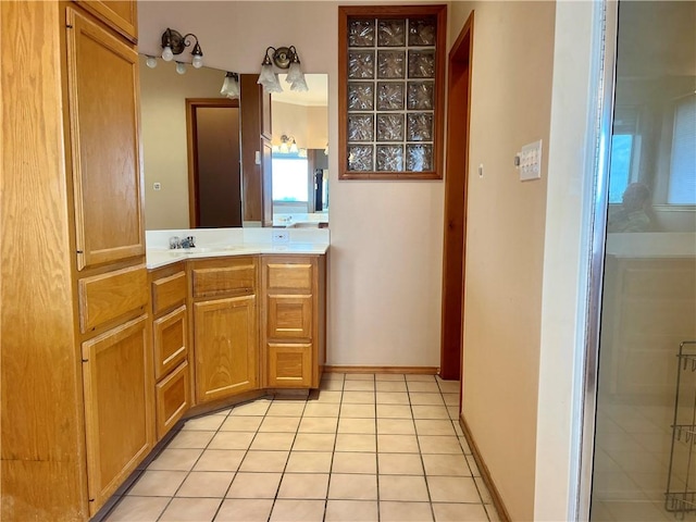 bathroom with tile patterned flooring, vanity, and a shower