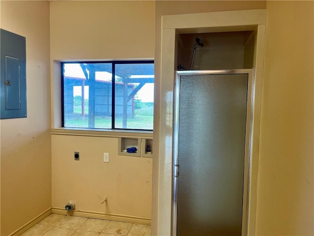 bathroom with tile patterned floors, electric panel, and a shower with door