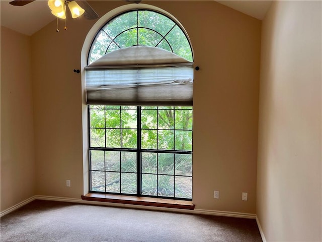 carpeted spare room with ceiling fan and lofted ceiling