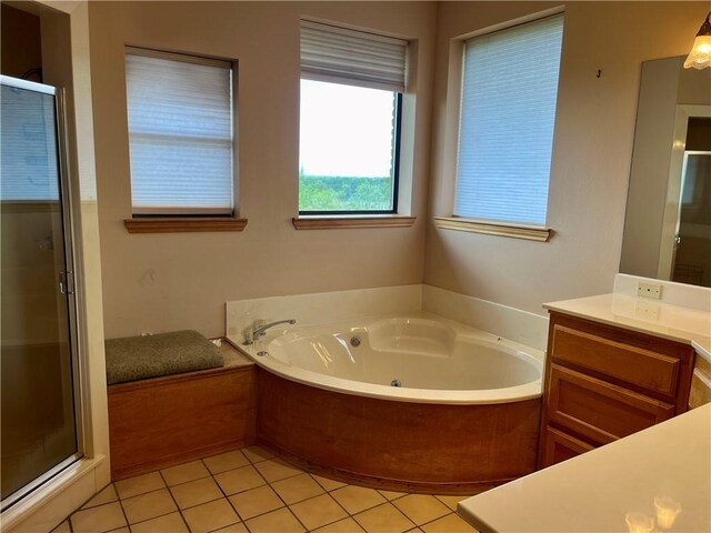 bathroom featuring plus walk in shower, tile patterned flooring, and vanity