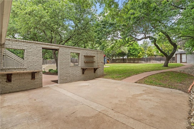 view of patio / terrace featuring an outdoor structure and fence