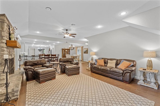 living area featuring lofted ceiling, wood finished floors, and visible vents