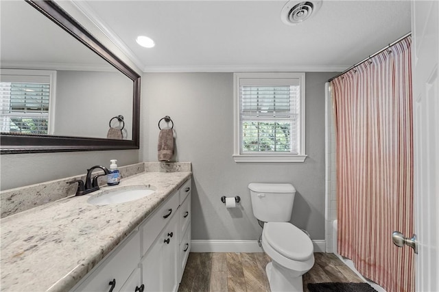 bathroom with toilet, wood finished floors, vanity, baseboards, and ornamental molding