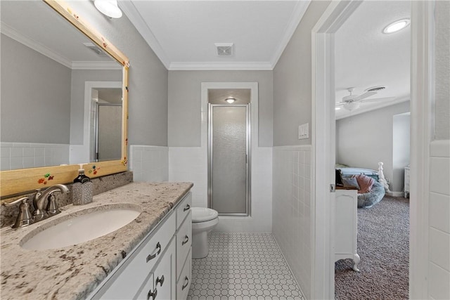 ensuite bathroom with visible vents, vanity, tile walls, a stall shower, and ensuite bath