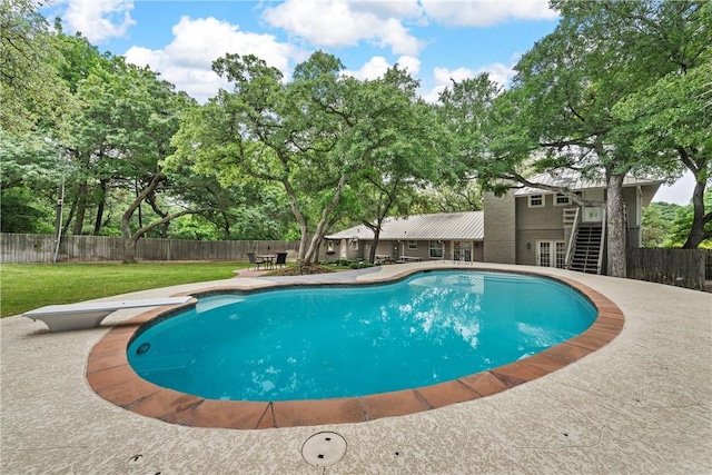 view of pool featuring a fenced in pool, a yard, a patio area, a fenced backyard, and stairs