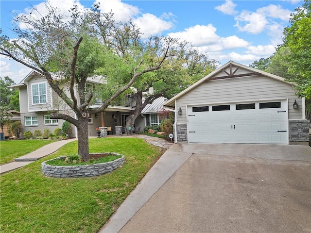 view of front of property featuring driveway, stone siding, a garage, and a front yard