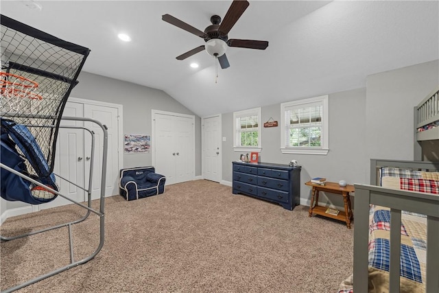 carpeted bedroom featuring baseboards, ceiling fan, vaulted ceiling, two closets, and recessed lighting