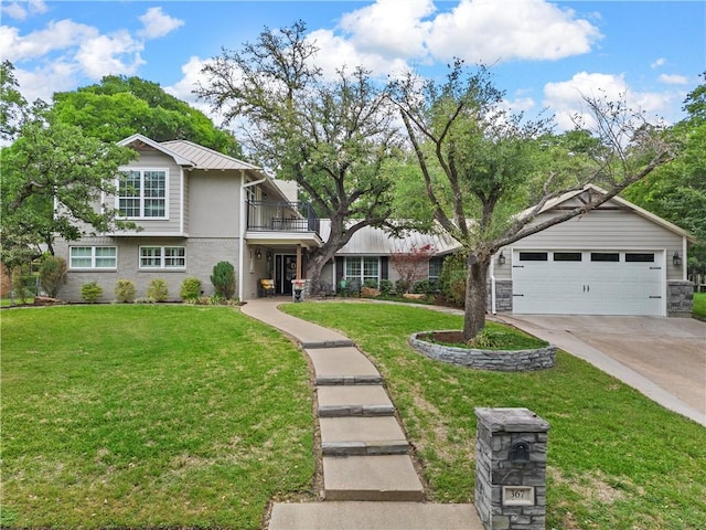 view of front of house with a front yard, metal roof, and a balcony