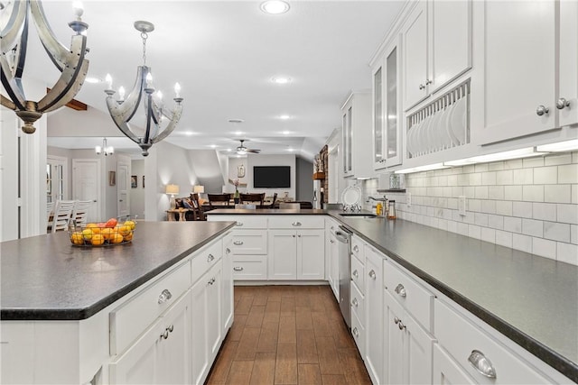 kitchen featuring dark countertops, tasteful backsplash, open floor plan, and stainless steel dishwasher