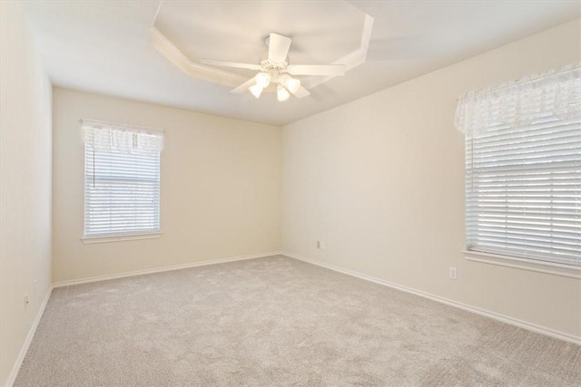 empty room with light carpet, ceiling fan, and baseboards