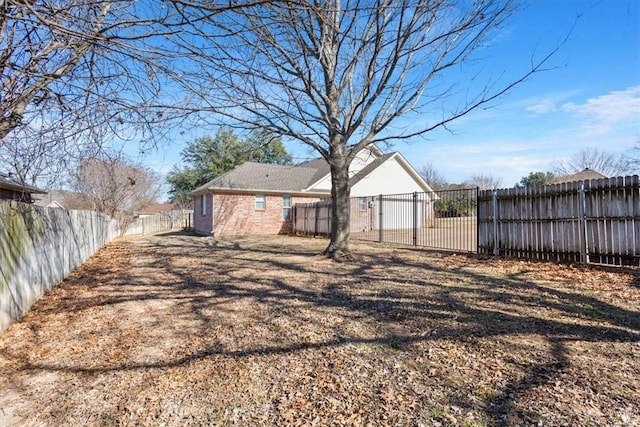 back of house featuring a fenced backyard