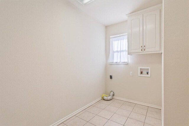 washroom with cabinet space, light tile patterned floors, baseboards, hookup for an electric dryer, and washer hookup