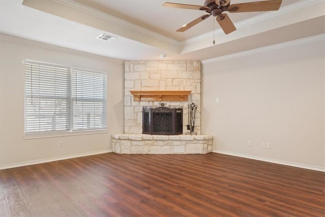 unfurnished living room featuring a tray ceiling, dark wood-style flooring, a fireplace, and visible vents