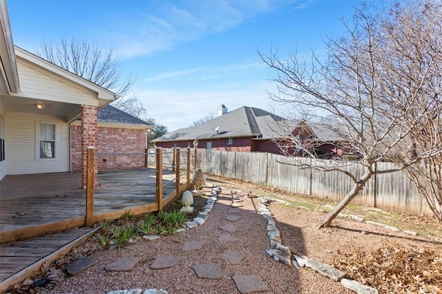 view of yard with a fenced backyard and a wooden deck