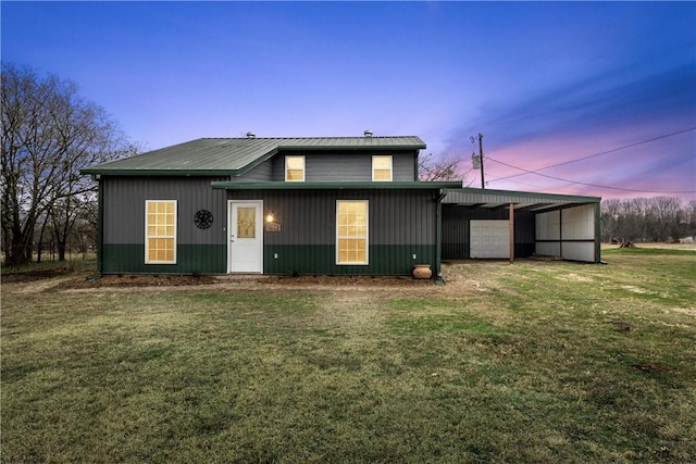 view of front facade with a garage, driveway, a carport, and a lawn