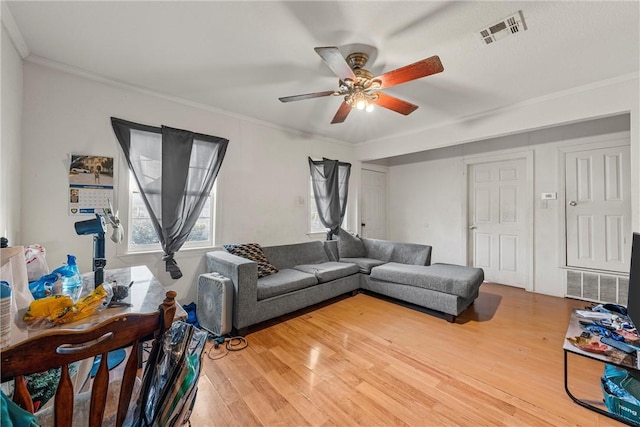 living room featuring crown molding, ceiling fan, and wood-type flooring