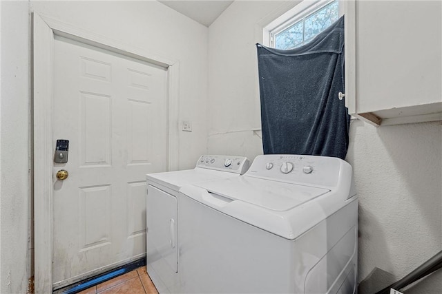 laundry area featuring washing machine and clothes dryer and tile patterned flooring