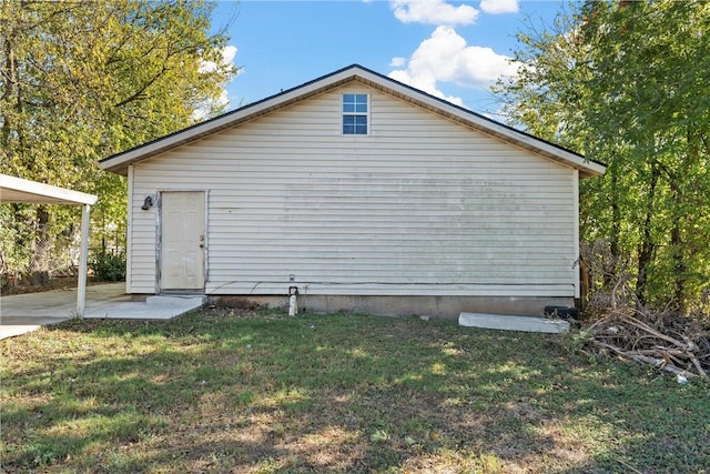 view of side of home with a yard