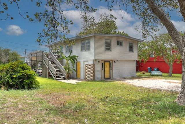 back of house featuring a yard