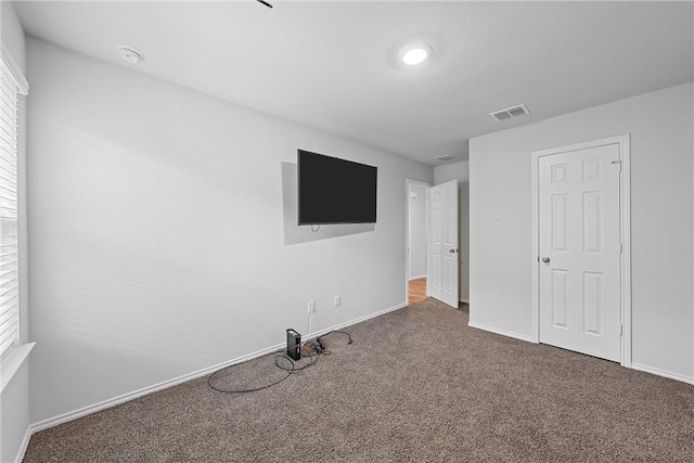 unfurnished bedroom featuring dark colored carpet