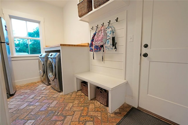 clothes washing area featuring separate washer and dryer