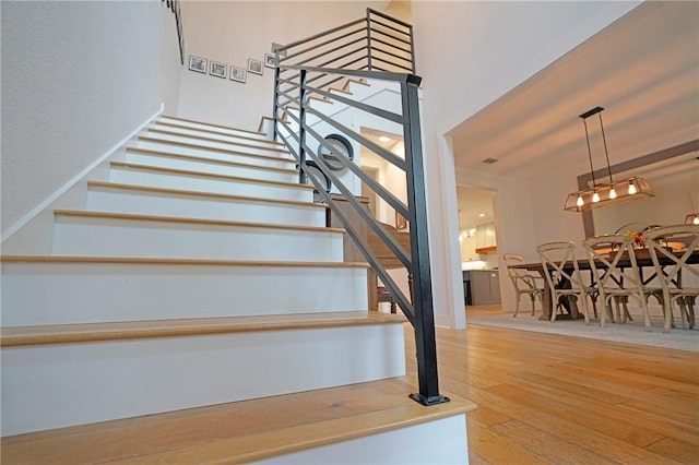 stairs with hardwood / wood-style floors