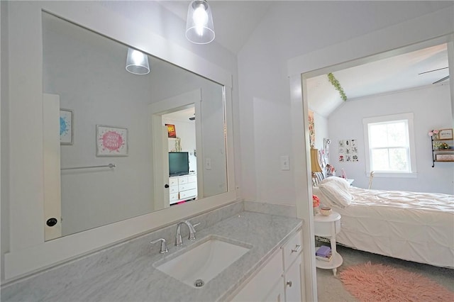 bathroom featuring lofted ceiling and vanity