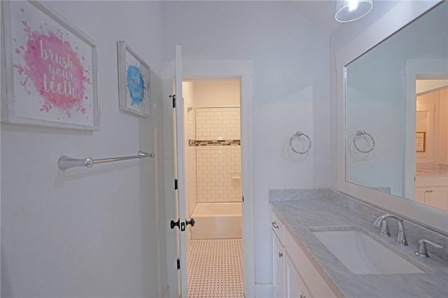 bathroom with vanity, tile patterned floors, and tiled shower / bath combo