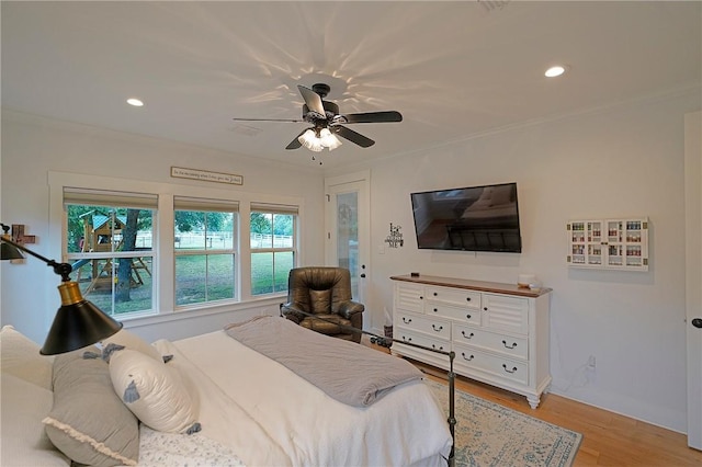 bedroom featuring ceiling fan, crown molding, and light wood-type flooring