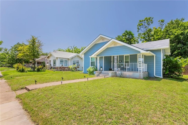 view of front of property with covered porch and a front lawn