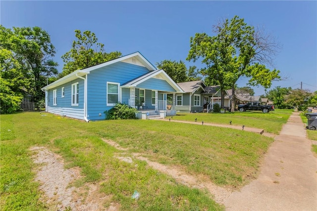 view of front of house with covered porch and a front yard